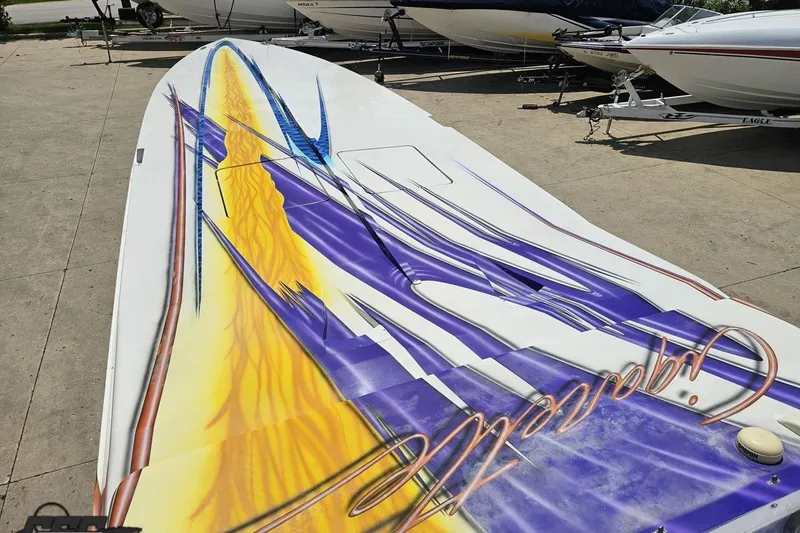 Slide: The Image of 2002 Cigarette 42' Tiger boat with vibrant abstract graphics on deck. - 68