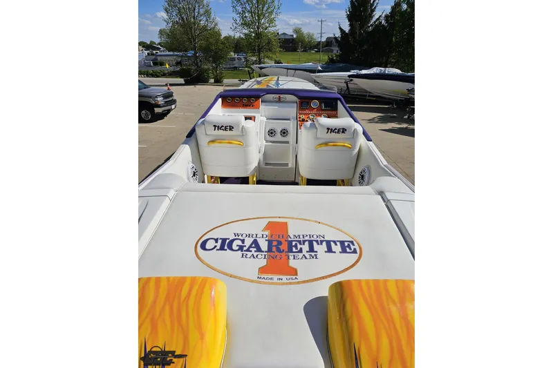 Slide: The Image of 2002 Cigarette 42' Tiger boat interior with racing team logo, vibrant yellow and purple accents. - 46