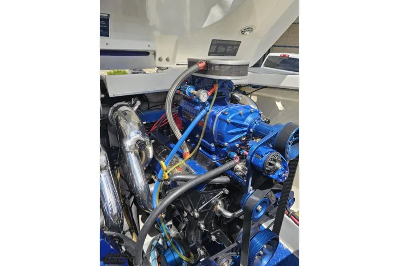 Slide: The Image of Engine of a 2002 Cigarette 42' Tiger boat, featuring blue components and chrome details. - 96