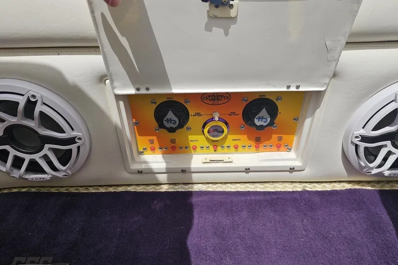 Slide: The Image of Control panel of a 2002 Cigarette 42' Tiger boat with speakers and switches. - 91