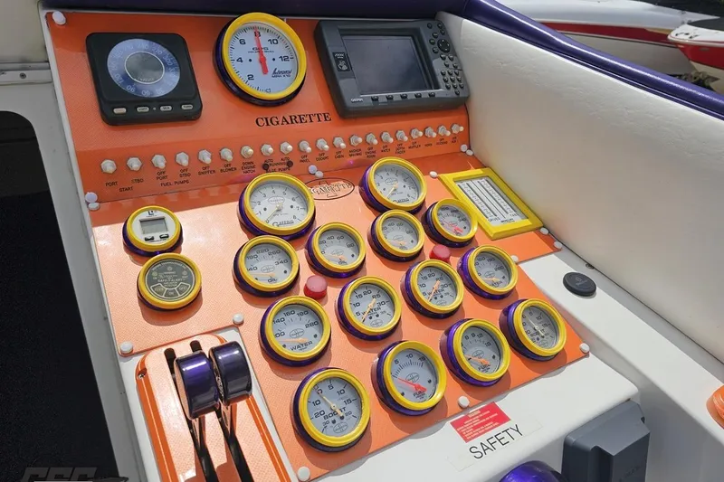 Slide: The Image of Dashboard of a 2002 Cigarette 42' Tiger boat with gauges and controls. - 66