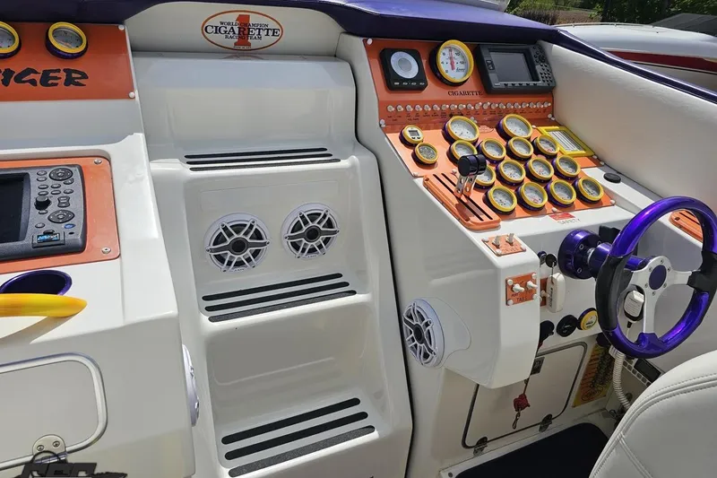 Slide: The Image of Cockpit of a 2002 Cigarette 42' Tiger boat with gauges and controls. - 63