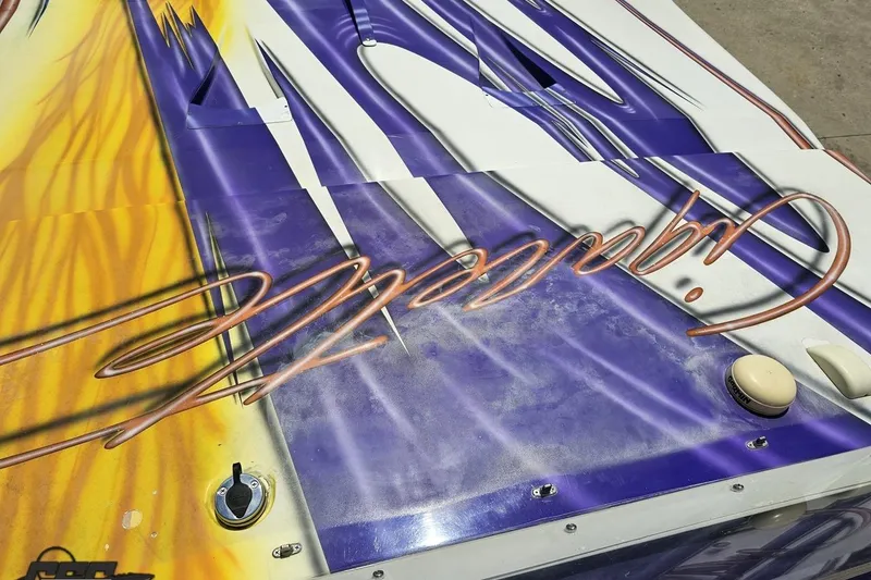 Slide: The Image of 2002 Cigarette 42' Tiger boat with vibrant custom paint and logo design. - 69