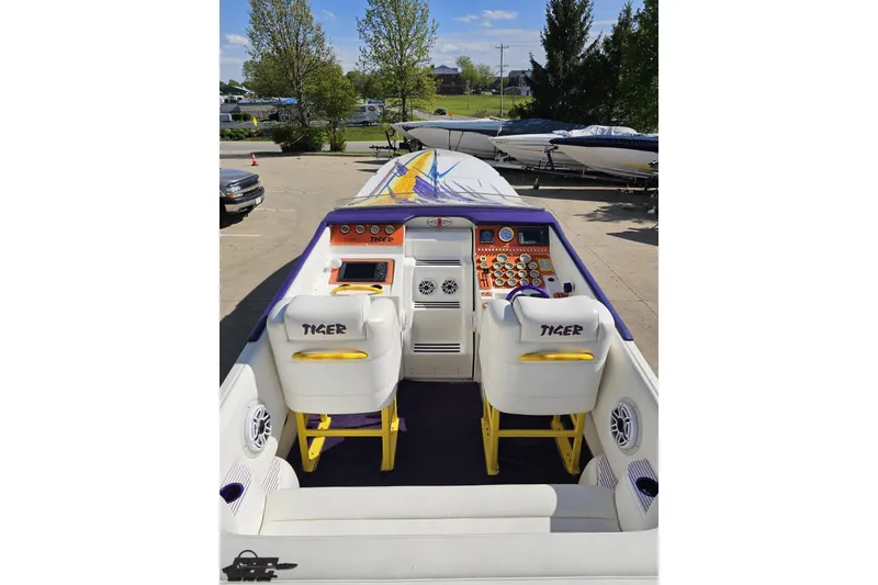 Slide: The Image of 2002 Cigarette 42' Tiger boat interior with vibrant dashboard and seating. - 49