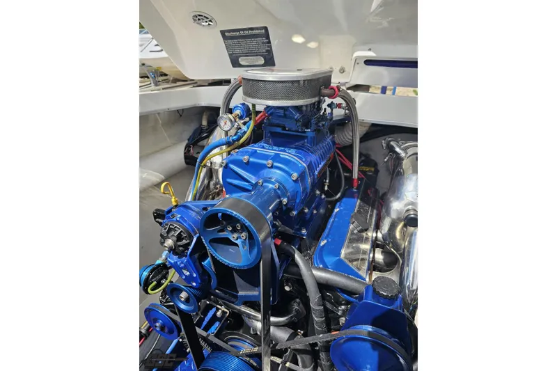 Slide: The Image of Engine of a 2002 Cigarette 42' Tiger boat, showcasing blue components and intricate details. - 95
