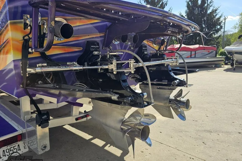 Slide: The Image of Rear view of a 2002 Cigarette 42' Tiger boat with dual Mercury outboard engines. - 33