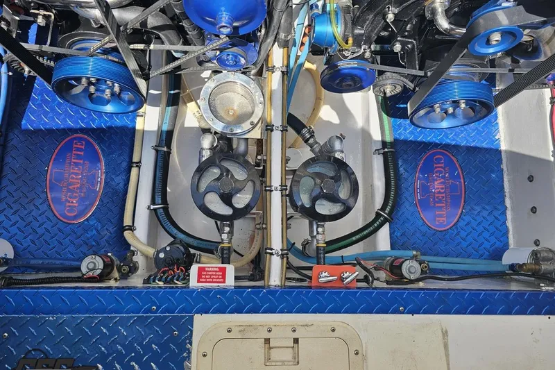 Slide: The Image of Engine compartment of a 2002 Cigarette 42' Tiger boat with blue accents and components. - 97