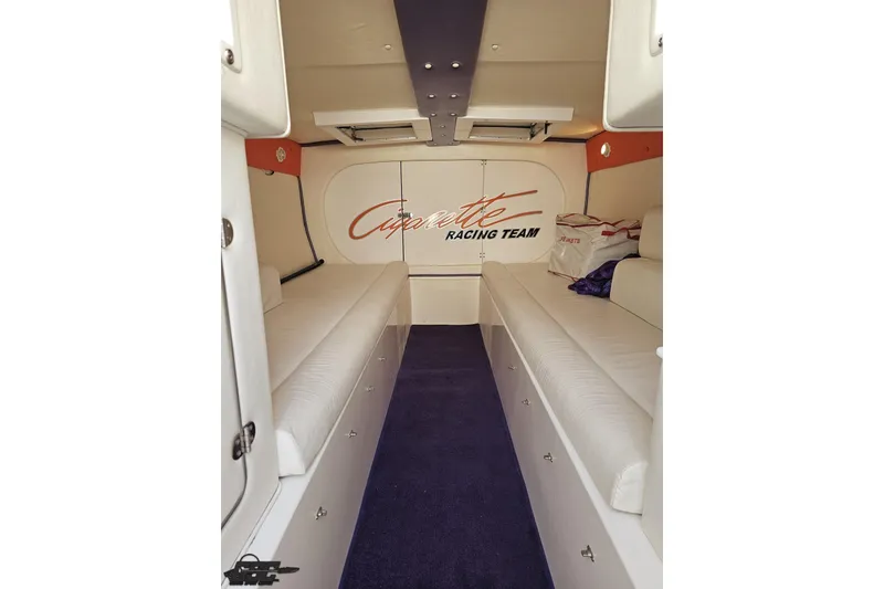 Slide: The Image of Interior of 2002 Cigarette 42' Tiger boat with white seating and purple carpet. - 74