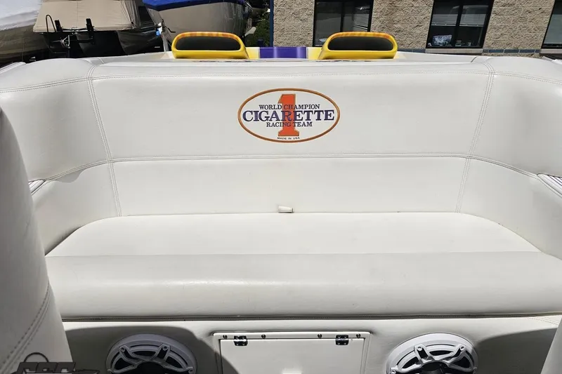 Slide: The Image of 2002 Cigarette 42' Tiger boat interior with white seating and logo. - 89