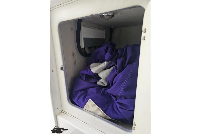 Slide: The Image of Storage compartment in a 2002 Cigarette 42' Tiger boat with purple fabric inside. - 76
