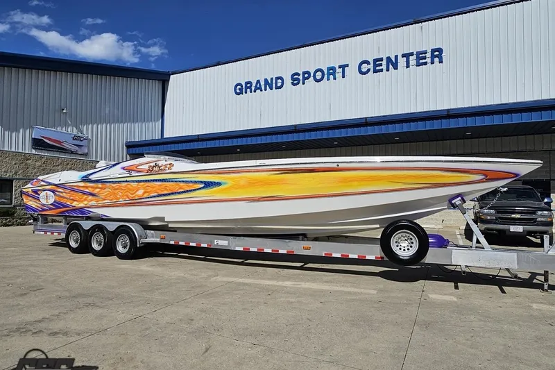 Slide: The Image of 2002 Cigarette 42' Tiger boat with vibrant graphics at Grand Sport Center. - 14