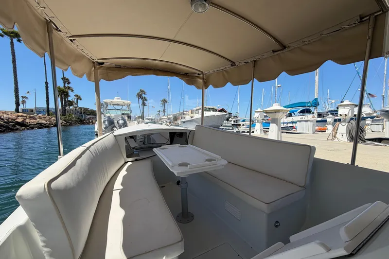 Slide: The Image of Interior view of a 1996 Duffy 16 boat docked at a marina under a sunny sky. - 8