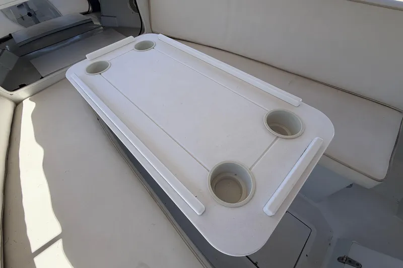 Slide: The Image of White boat interior with cup holders on a table, Duffy 16, 1996 model. - 13
