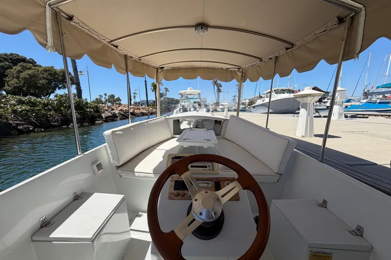 Slide: The Image of Interior view of a 1996 Duffy 16 boat with canopy and steering wheel. - 6