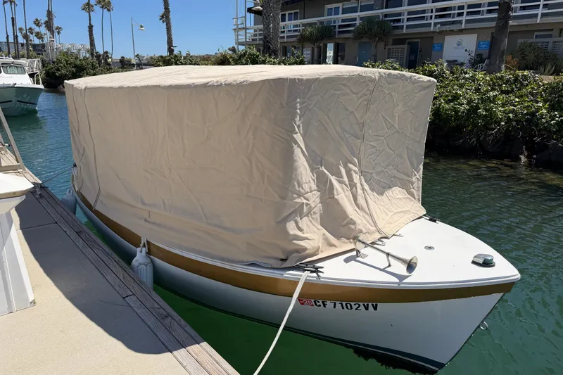 Slide: The Image of Covered 1996 Duffy 16 boat docked in a sunny marina setting. - 20