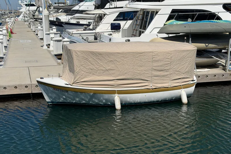 Slide: The Image of Covered 1996 Duffy 16 boat docked at marina with protective tarp. - 23