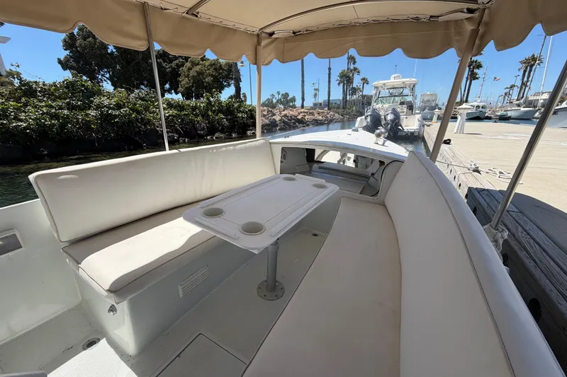 Slide: The Image of 1996 Duffy 16 boat interior with canopy, seating, and table at marina dock. - 12