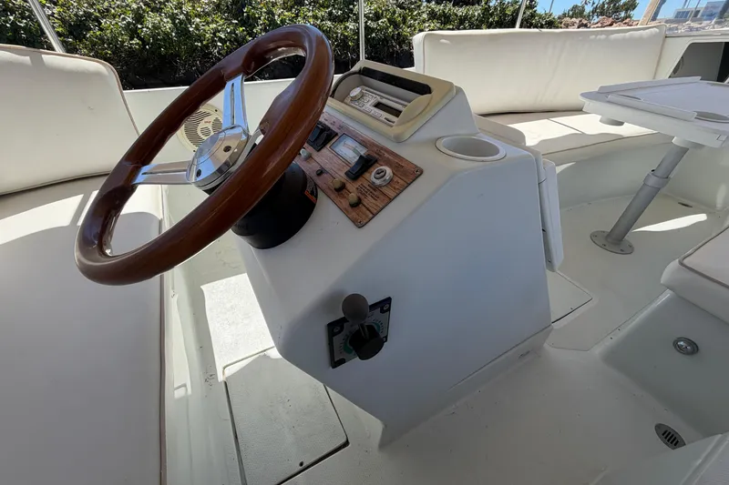 Slide: The Image of Interior of a 1996 Duffy 16 boat showing steering wheel and control panel. - 7