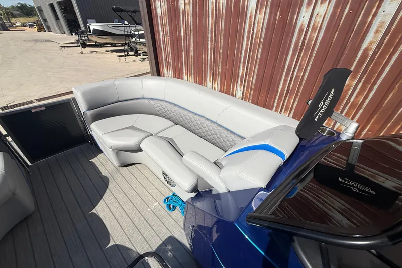 Slide: The Image of 2023 Manitou 25LXSHP boat interior with luxurious seating and modern design. - 8