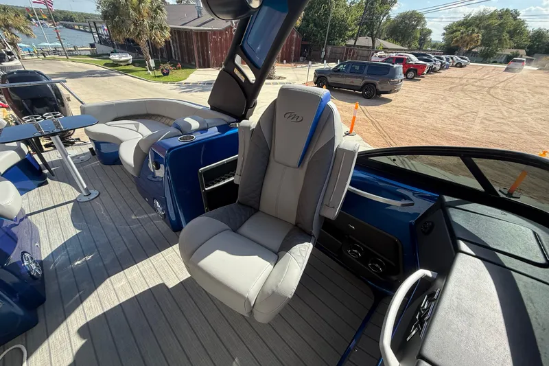 Slide: The Image of 2023 Manitou 25LXSHP pontoon boat interior with luxurious seating and modern design. - 7