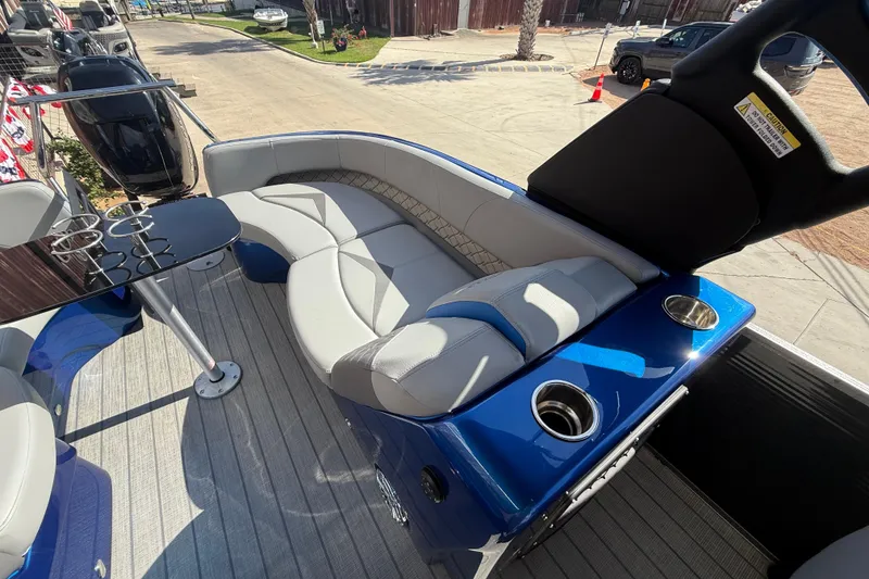 Slide: The Image of 2023 Manitou 25LXSHP boat interior with plush seating and sleek design. - 10