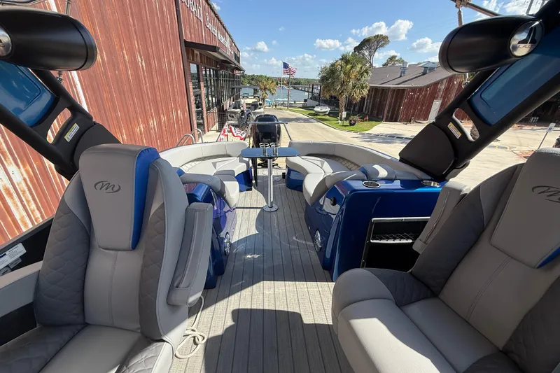 Slide: The Image of 2023 Manitou 25LXSHP pontoon boat interior with luxurious seating and modern design. - 5