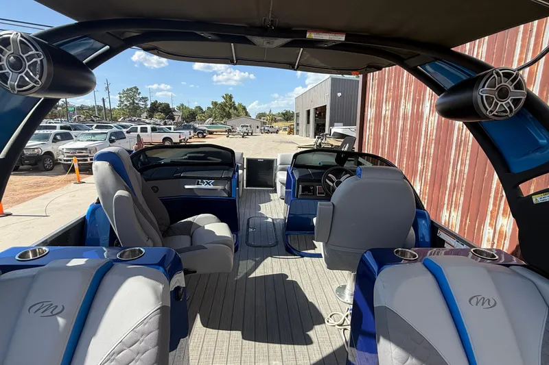 Slide: The Image of 2023 Manitou 25LXSHP pontoon boat interior with modern seating and audio system. - 4