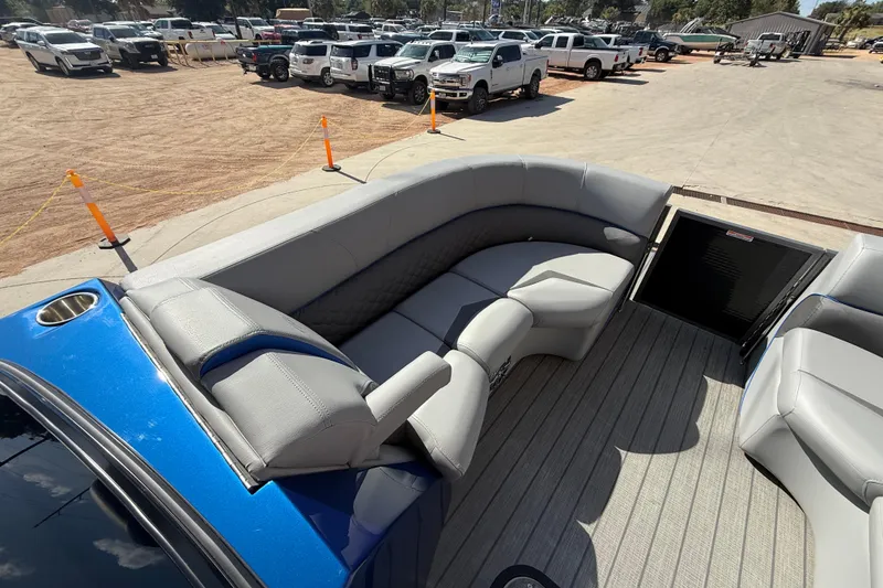Slide: The Image of 2023 Manitou 25LXSHP pontoon boat with luxurious gray seating and spacious deck. - 9