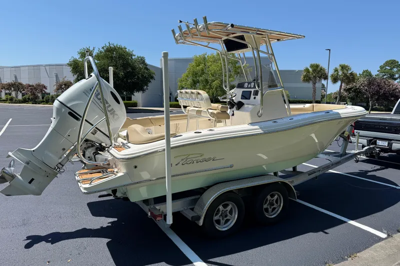 Slide: The Image of 2021 Pioneer 202 Islander boat on trailer, parked outdoors under clear blue sky. - 31