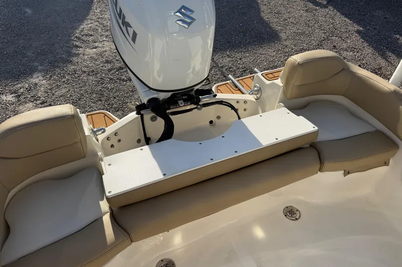 Slide: The Image of 2021 Pioneer 202 Islander boat interior with Suzuki outboard motor and beige seating. - 49