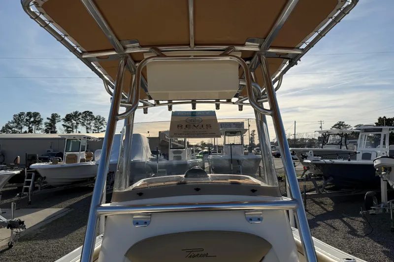 Slide: The Image of 2021 Pioneer 202 Islander boat with T-top, displayed in a marina setting. - 42