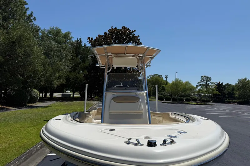 Slide: The Image of 2021 Pioneer 202 Islander boat with T-top in a sunny parking lot. - 36