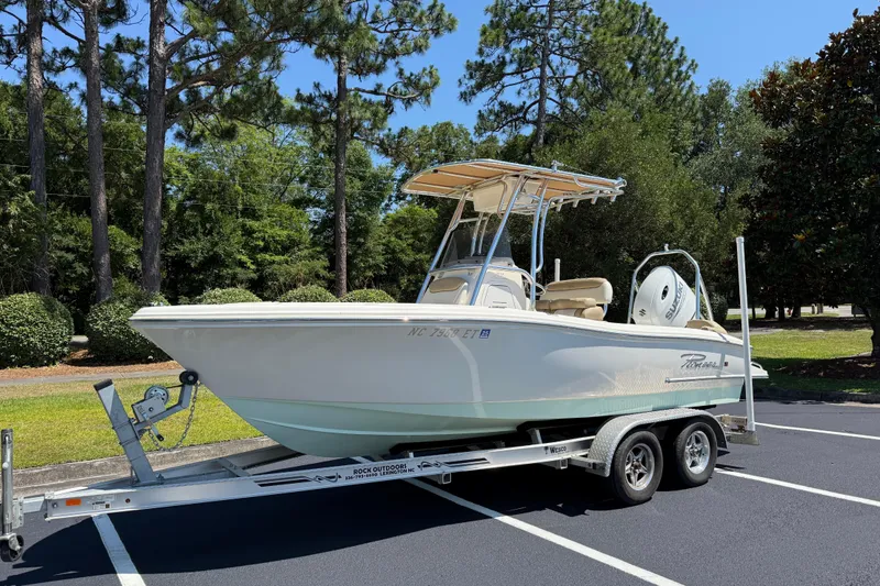 Slide: The Image of 2021 Pioneer 202 Islander boat on trailer in a scenic outdoor setting. - 22