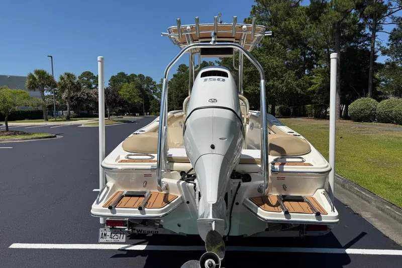 Slide: The Image of 2021 Pioneer 202 Islander boat with Yamaha 150 engine, parked outdoors. - 29