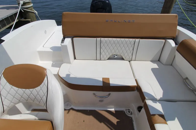 Slide: The Image of The image shows the cockpit of a 2022 Bayliner DX 2000 with brown and white seating. - 13