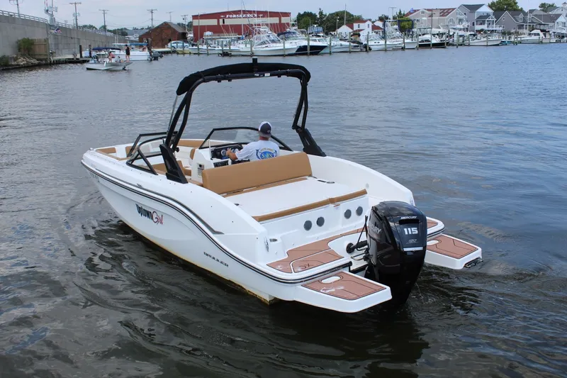 Slide: The Image of A 2022 Bayliner DX 2000 on calm waters. It features an outboard motor. - 7