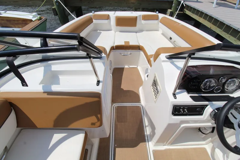 Slide: The Image of The image shows the cockpit of a 2022 Bayliner DX 2000 with beige seating and a modern dashboard. - 21