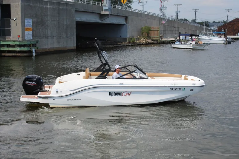 Slide: The Image of A 2022 Bayliner DX 2000 cruising on a river. It features a Mercury outboard motor. - 1