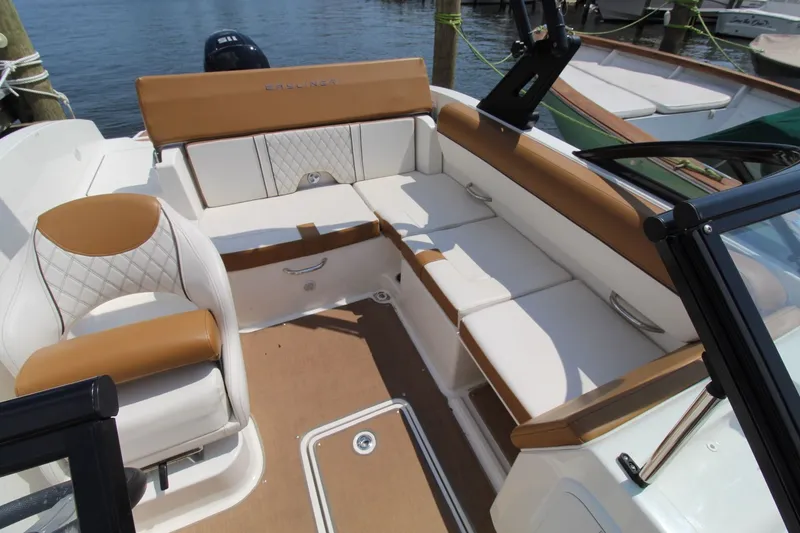 Slide: The Image of The image shows the cockpit of a 2022 Bayliner DX 2000 with white and brown seating. - 11
