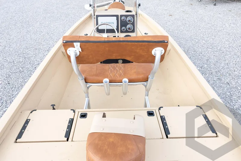 Slide: The Image of 2026 G3 Bay 19 GX boat interior with tan seating and Garmin dashboard. - 15