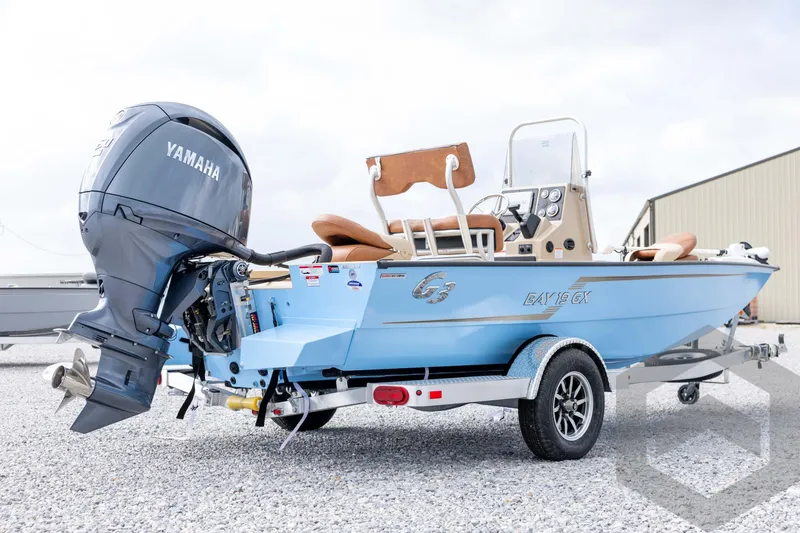 Slide: The Image of 2026 G3 Bay 19 GX boat with Yamaha engine on trailer, parked outdoors. - 4