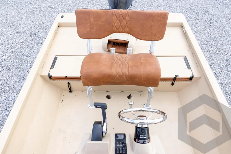 Slide: The Image of 2026 G3 Bay 19 GX boat interior with brown seats and steering wheel. - 23