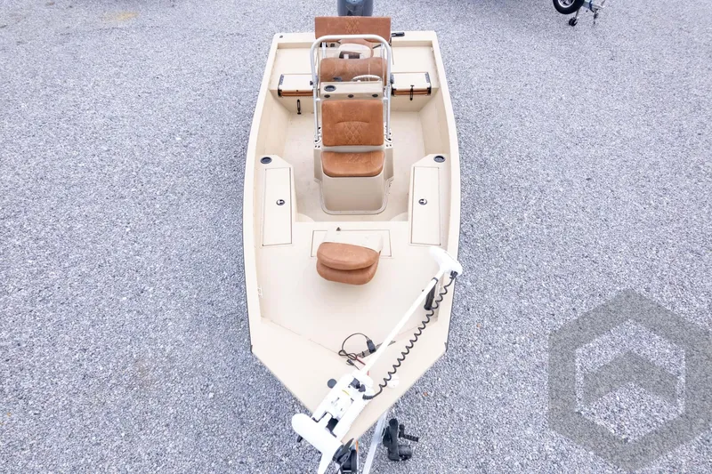Slide: The Image of 2026 G3 Bay 19 GX boat with tan seats on gravel surface. - 42