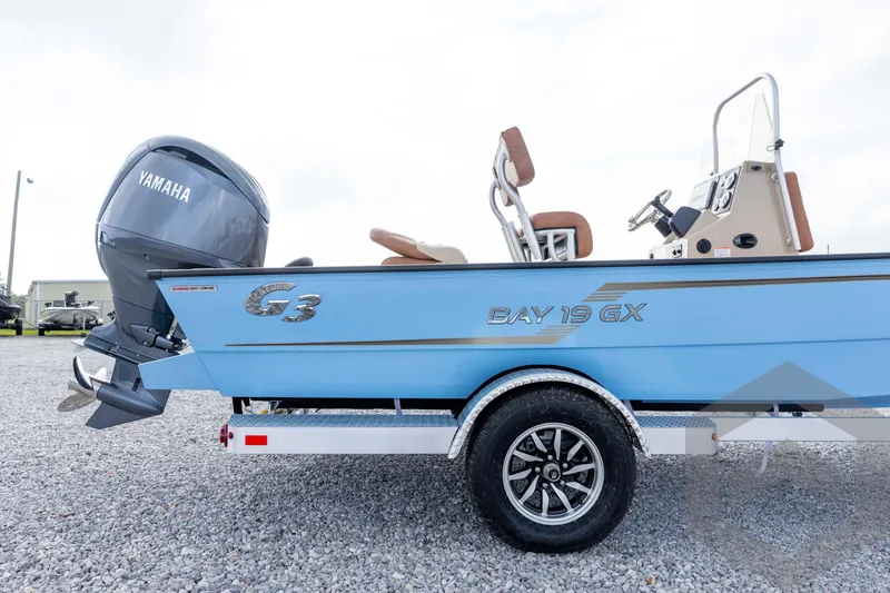 Slide: The Image of 2026 G3 Bay 19 GX boat with Yamaha engine on gravel surface. - 10