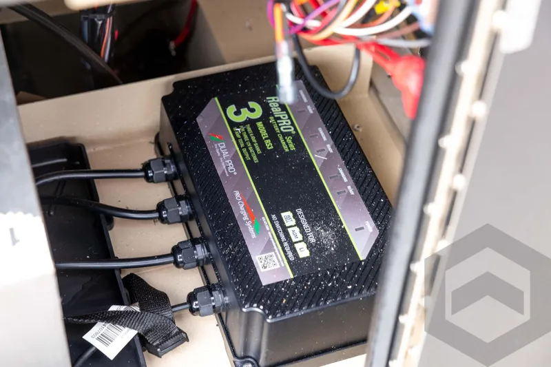 Slide: The Image of Battery charger system in a 2026 G3 Bay 19 GX boat, featuring multiple cables and connections. - 26