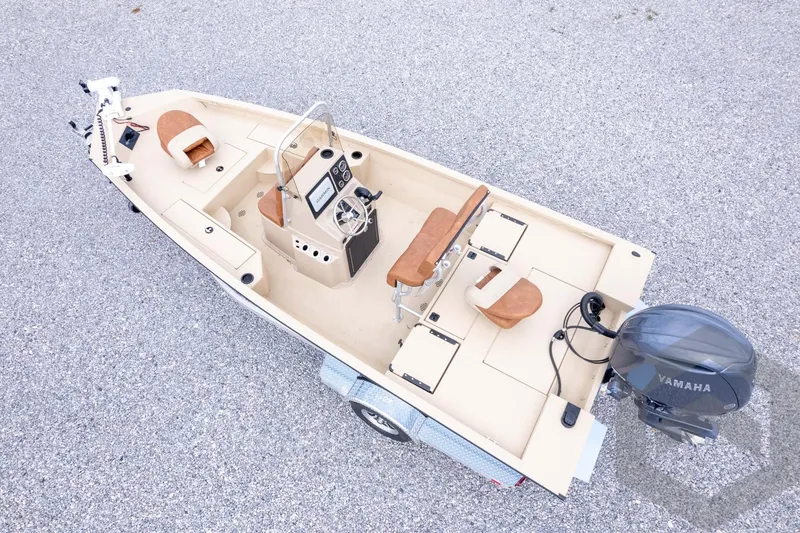 Slide: The Image of 2026 G3 Bay 19 GX boat with Yamaha motor, beige interior, and steering console on trailer. - 34