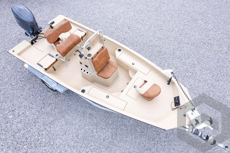 Slide: The Image of 2026 G3 Bay 19 GX boat with brown seats and motor on gravel surface. - 38