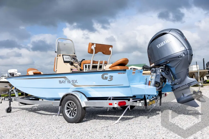 Slide: The Image of 2026 G3 Bay 19 GX boat with Yamaha outboard motor on a trailer, under cloudy sky. - 6
