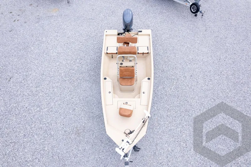 Slide: The Image of 2026 G3 Bay 19 GX boat with tan seating, viewed from above on gravel surface. - 37