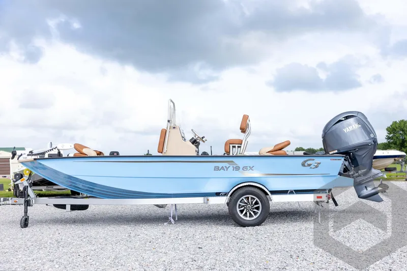 Slide: The Image of 2026 G3 Bay 19 GX boat with Yamaha motor on a trailer, parked outdoors. - 7